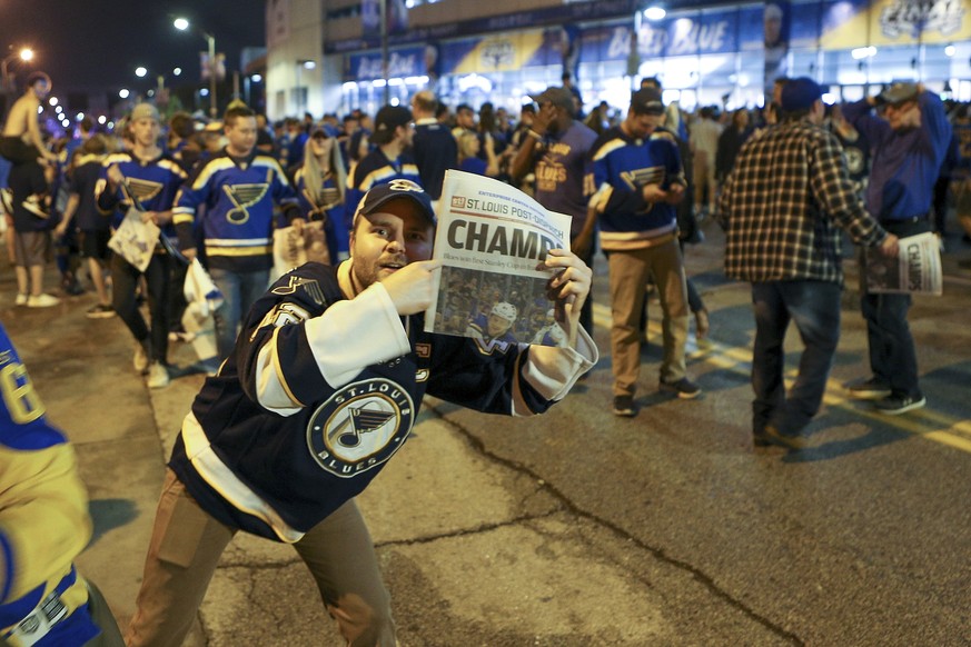 St. Louis Blues fans celebrate in the streets in front of the Enterprise Center in St. Louis after the St. Louis Blues defeated the Boston Bruins 4-1 in Game 7 of the Stanley Cup Final in Boston, Wedn ...