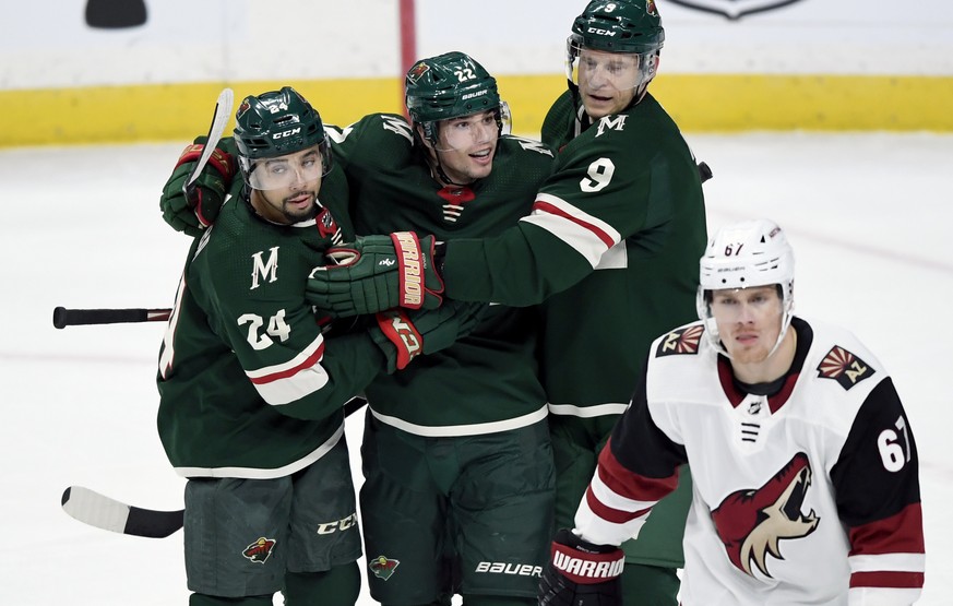 Minnesota Wild&#039;s Matt Dumba (24) and Mikko Koivu (9), of Finland, congratulate Kevin Fiala (22), of Switzerland, on his goal as Arizona Coyotes&#039; Lawson Crouse (67) skates to the bench during ...