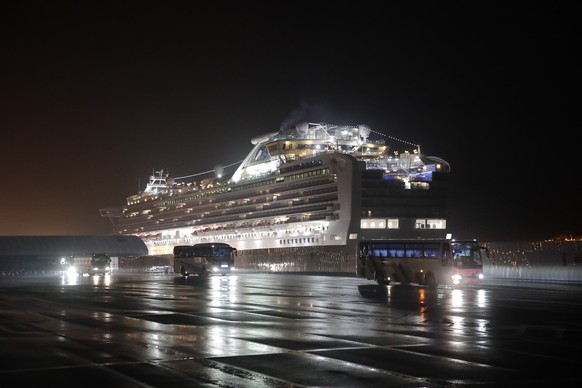 FILE - In this Feb. 17, 2020, file photo, buses carrying American passengers from the quarantined Diamond Princess cruise ship leave a port in Yokohama, near Tokyo. After 14 days, an extraordinary qua ...