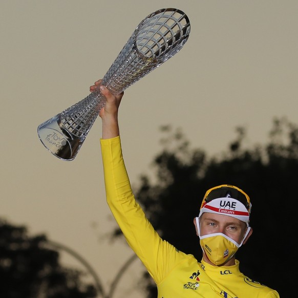 Slovenia&#039;s Tadej Pogacar, wearing the overall leader&#039;s yellow jersey, celebrates next to his two other jersey&#039;s, the best climber&#039;s dotted jersey and the best young rider&#039;s wh ...