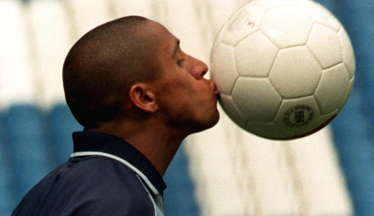 Real Madrid&#039;s Brazilian player Roberto Carlos kisses the ball during a training session in Madrid&#039;s Santiago Bernabeu stadium Tuesday May 12 1998. Real play Italian side Juventus in the Euro ...