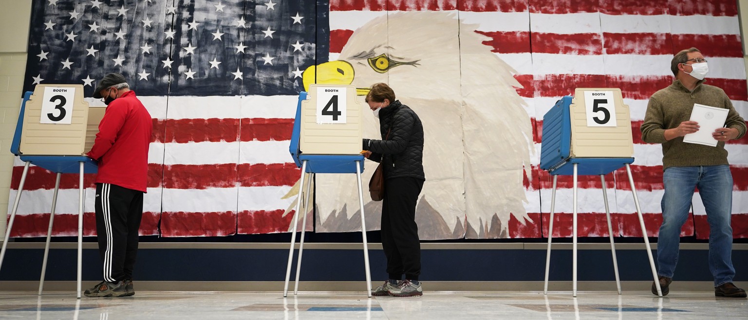 CORRECTS MONTH TO NOVEMBER Voters cast their ballots under a giant mural at Robious Elementary school in Midlothian, Va., Tuesday Nov. 3, 2020. Poll workers said that traffic was slow due to all the e ...