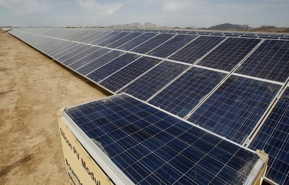 FILE - In this Sept. 30, 2011, file photo, solar panel installation continues at a rapid pace at the Mesquite Solar 1 facility under construction in Arlington, Ariz. As states across the U.S. West bee ...