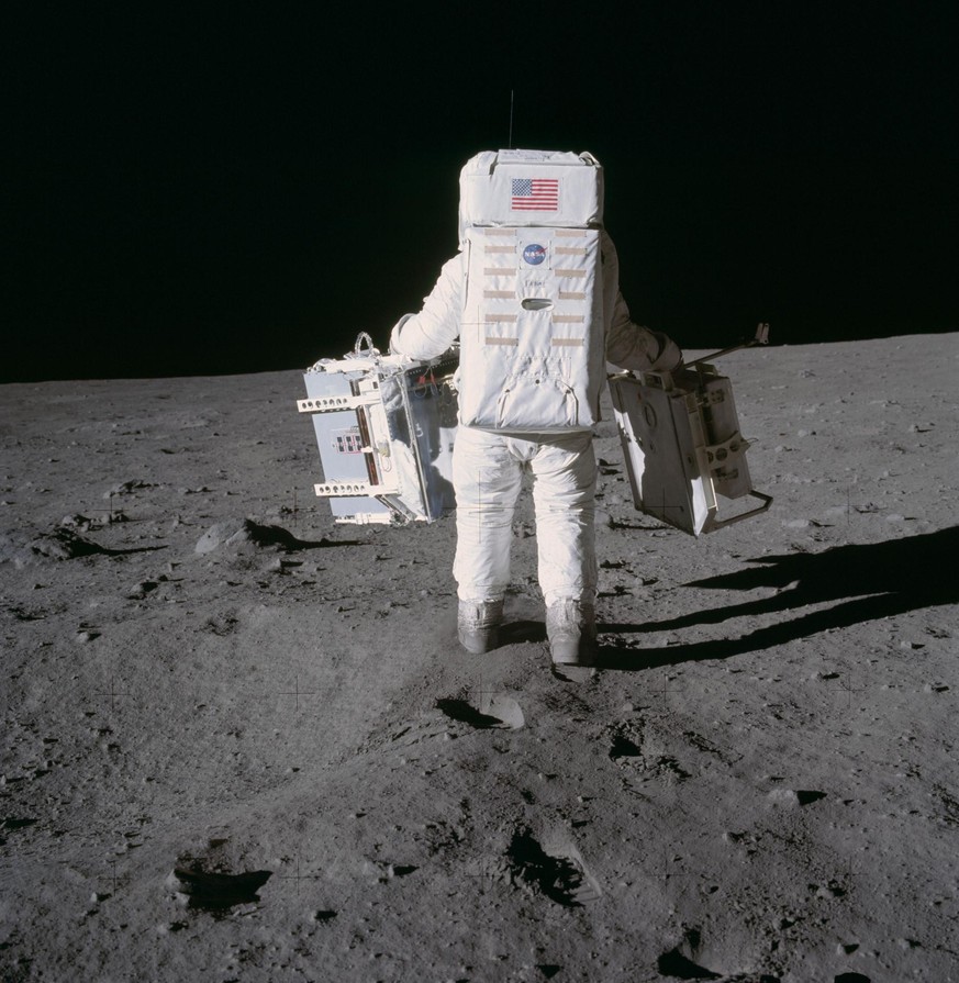 Astronaut Edwin E. Aldrin Jr., lunar module pilot, moves toward a position to deploy two components of the Early Apollo Scientific Experiments Package (EASEP) on the surface of the Moon during the Apo ...