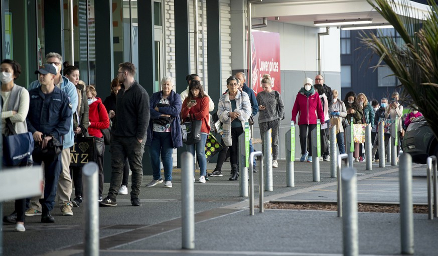 People queue early morning outside a supermarket in Hobsonville, Auckland, as New Zealand prepares to move into Covid-19 Alert Level 3, Wednesday, Aug. 12, 2020. New Zealand Prime Minister Jacinda Ard ...