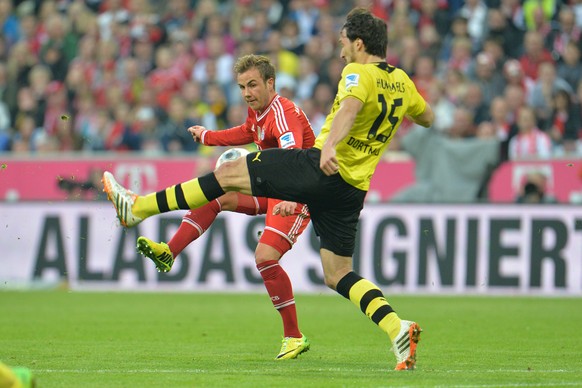 Bayern&#039;s Mario Goetze, left, and Dortmund&#039;s Mats Hummels challenge for the ball during the soccer match between FC Bayern Munich and Borussia Dortmund in Munich, Germany, on Saturday, April  ...