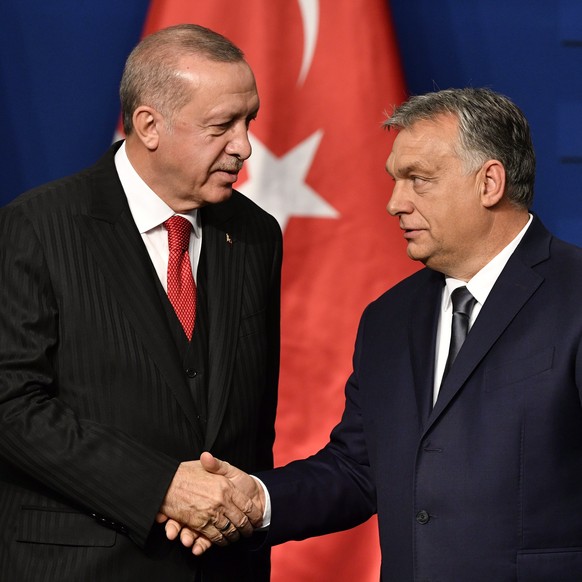 epa07979152 Turkish President Recep Tayyip Erdogan (L) and Hungarian Prime Minister Viktor Orban shake hands during a joint press conference after their meeting in Budapest, Hungary, 07 November 2019. ...
