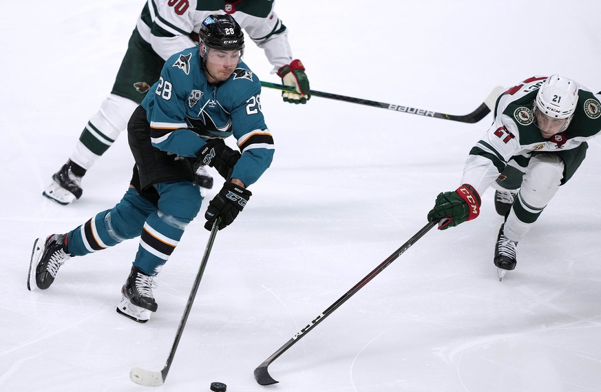 San Jose Sharks right wing Timo Meier (28) battles for the puck against Minnesota Wild defenseman Carson Soucy (21) during the third period of an NHL hockey game in San Jose, Calif., Monday, March 29, ...
