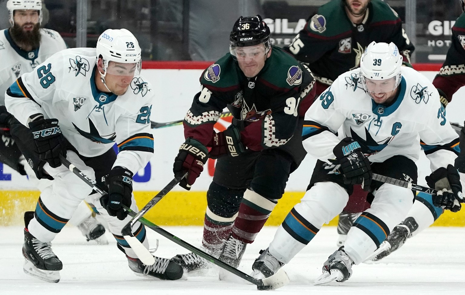 San Jose Sharks right wing Timo Meier, left, controls the puck as Arizona Coyotes right wing Christian Fischer, center, and Sharks center Logan Couture, right, arrive late during the third period of a ...