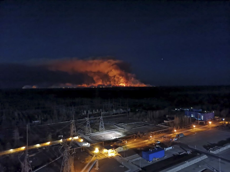 In this photo taken from the roof of Ukraine&#039;s Chernobyl nuclear power plant late Friday April 10, 2020, a forest fire is seen burning near the plant inside the exclusion zone. Ukrainian firefigh ...