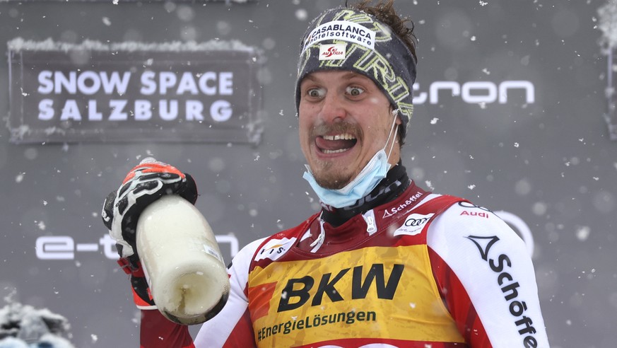 First placed Austria&#039;s Manuel Feller, left, and third placed Austria&#039;s Marco Schwarz celebrates on the podium of an alpine ski, men&#039;s World Cup slalom in Flachau, Austria, Saturday, Jan ...