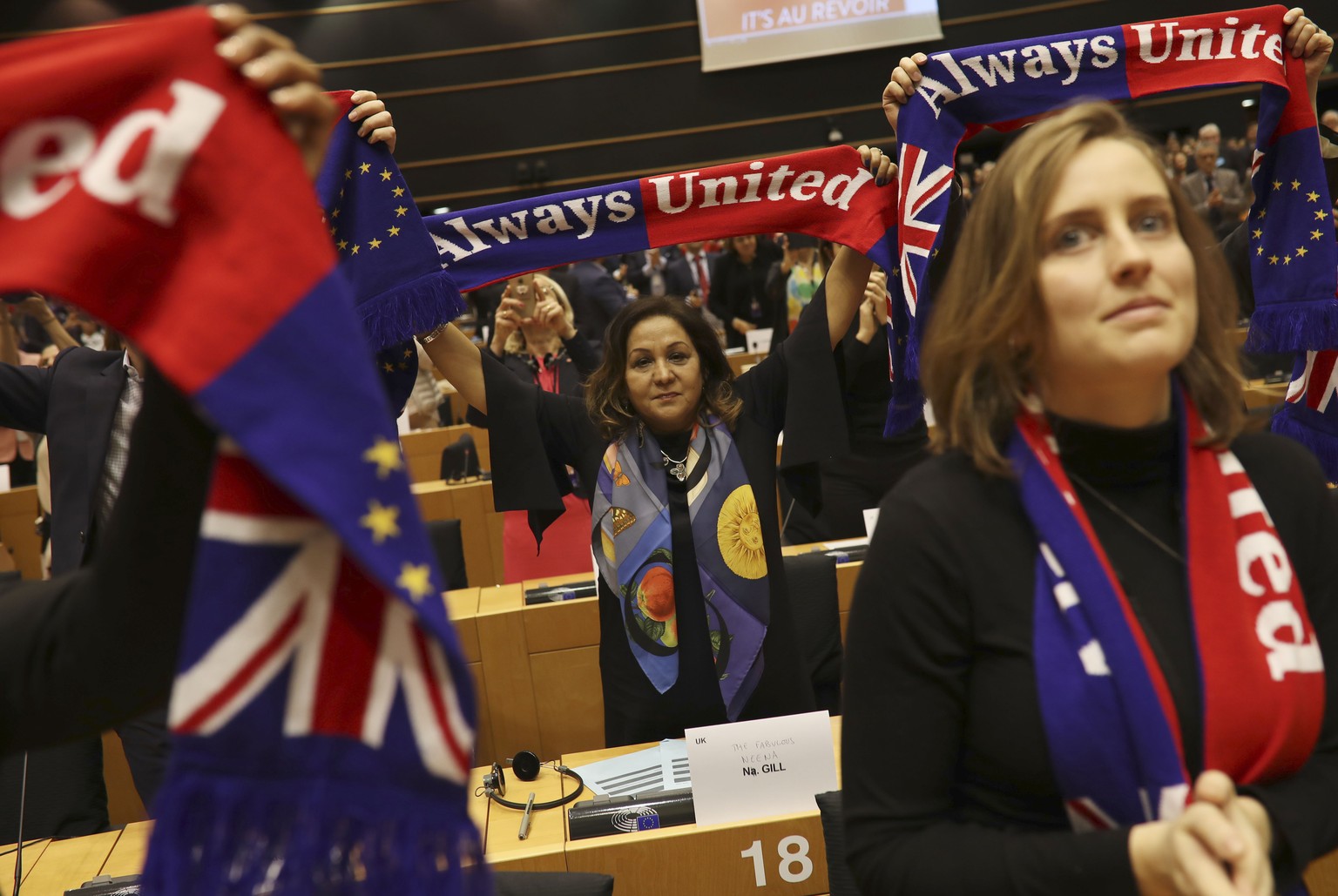British MEP&#039;s hold up scarves during a ceremony prior to the vote on the UK&#039;s withdrawal from the EU, the final legislative step in the Brexit proceedings, at the European Parliament in Brus ...