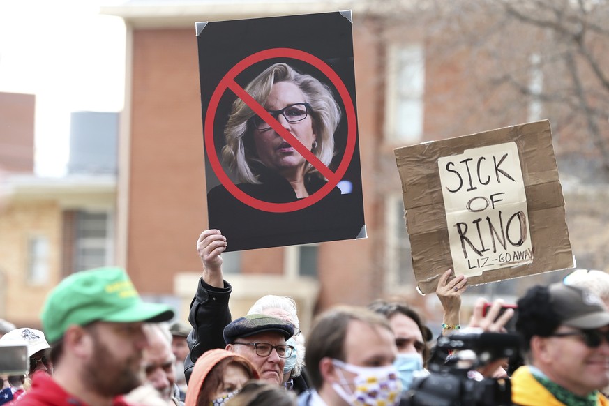 Protesters hold anti-U.S. Rep. Liz Cheney, R-Wyo., signs during a rally Thursday, Jan. 28, 2021, outside the Wyoming State Capitol in Cheyenne. Gaetz spoke to hundreds, bashing Rep. Cheney after she v ...
