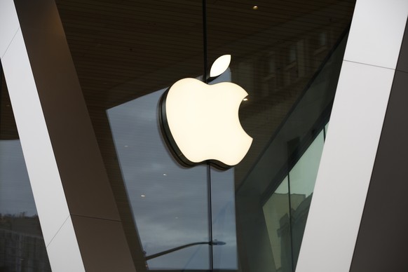 FILE - In this Saturday, March 14, 2020, file photo, an Apple logo adorns the facade of the downtown Brooklyn Apple store in New York. Demand for the iPhone drove Apple net income, which more than dou ...