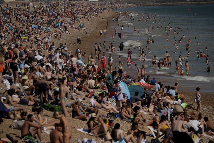 On Britain&#039;s hottest day of the year so far with temperatures reaching 32.6 degrees at Heathrow, people relax on Brighton Beach in Brighton, England, Wednesday, June 24, 2020. The British governm ...