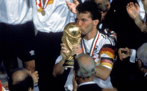 German soccer team players celebrate after winning the Soccer World Cup final in the Olympic Stadium, in Rome, Italy, on July 8, 1990. Germany defeated Argentina 1-0 to win the cup. Player kissing the ...