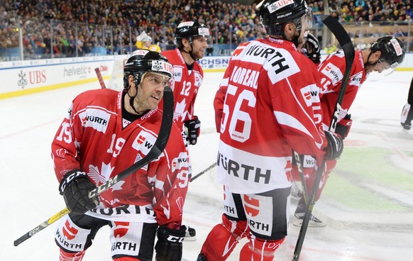 Canadas goalgetter Andrew Ebbett celebrates with the team after scoring 1:1 during the game between Team Canada and HC Davos at the 91th Spengler Cup ice hockey tournament in Davos, Switzerland, Thurs ...