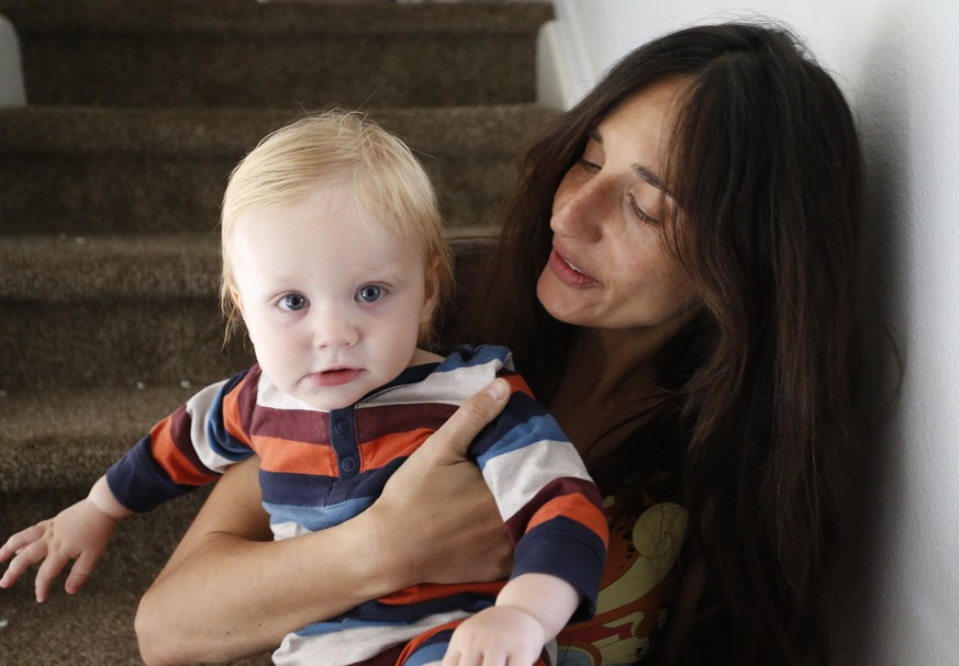In this Thursday, Oct. 20, 2016 photo, vegan mother Fulvia Serra holds her 1-year-old son, Sebastiano, at home in Fort Collins, Colo. Serra, originally from Italy, and her husband, Scott, are raising  ...