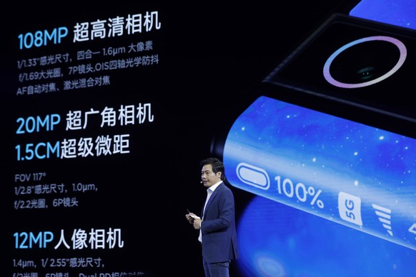 epa07865510 Lei Jun, Founder and CEO of Chinese mobile internet company Xiaomi Technology Co. Ltd., introduces the Xiaomi MIX Alpha smartphone during the Xiaomi new 5G smartphone product launch ceremo ...