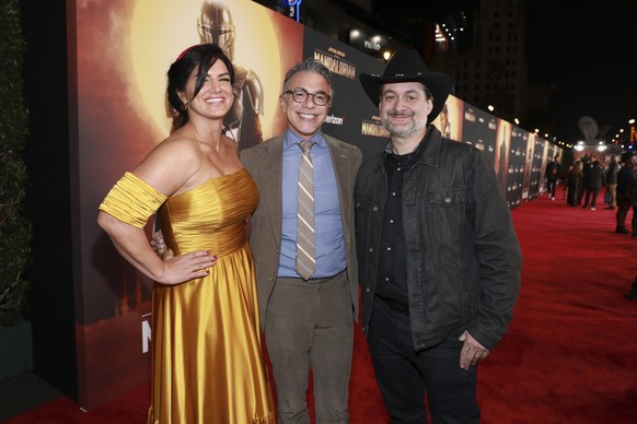 Gina Carano, from left, Ricky Strauss, and Dave Filoni attend the LA Premiere of &quot;The Mandalorian&quot; at the El Capitan Theatre on Wednesday, Nov. 13, 2019, in Los Angeles. (Photo by Mark Von H ...