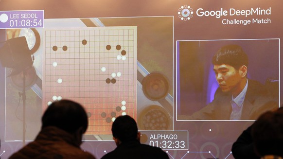 South Korean professional Go player Lee Sedol, right, appears on the screen during the second match of the Google DeepMind Challenge Match against Google&#039;s artificial intelligence program, AlphaG ...