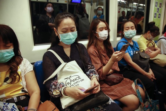 epa08243278 Commuters wearing protective masks ride the underground or MRT (Metropolitan Rapid Transit) in Bangkok, Thailand, 24 February 2020. The number of people infected with COVID-19 according to ...