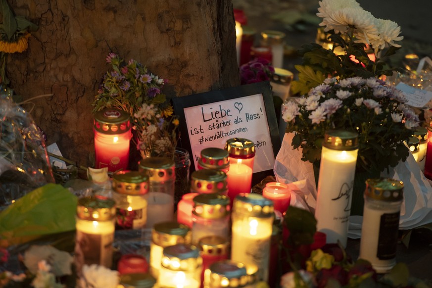 epa08798705 Candles and a sign reading &#039;Liebe ist staerker als Hass&#039; (Love is stronger than hate) are seen at the crime scene of multiple shootings in the first district of Vienna, Austria,  ...