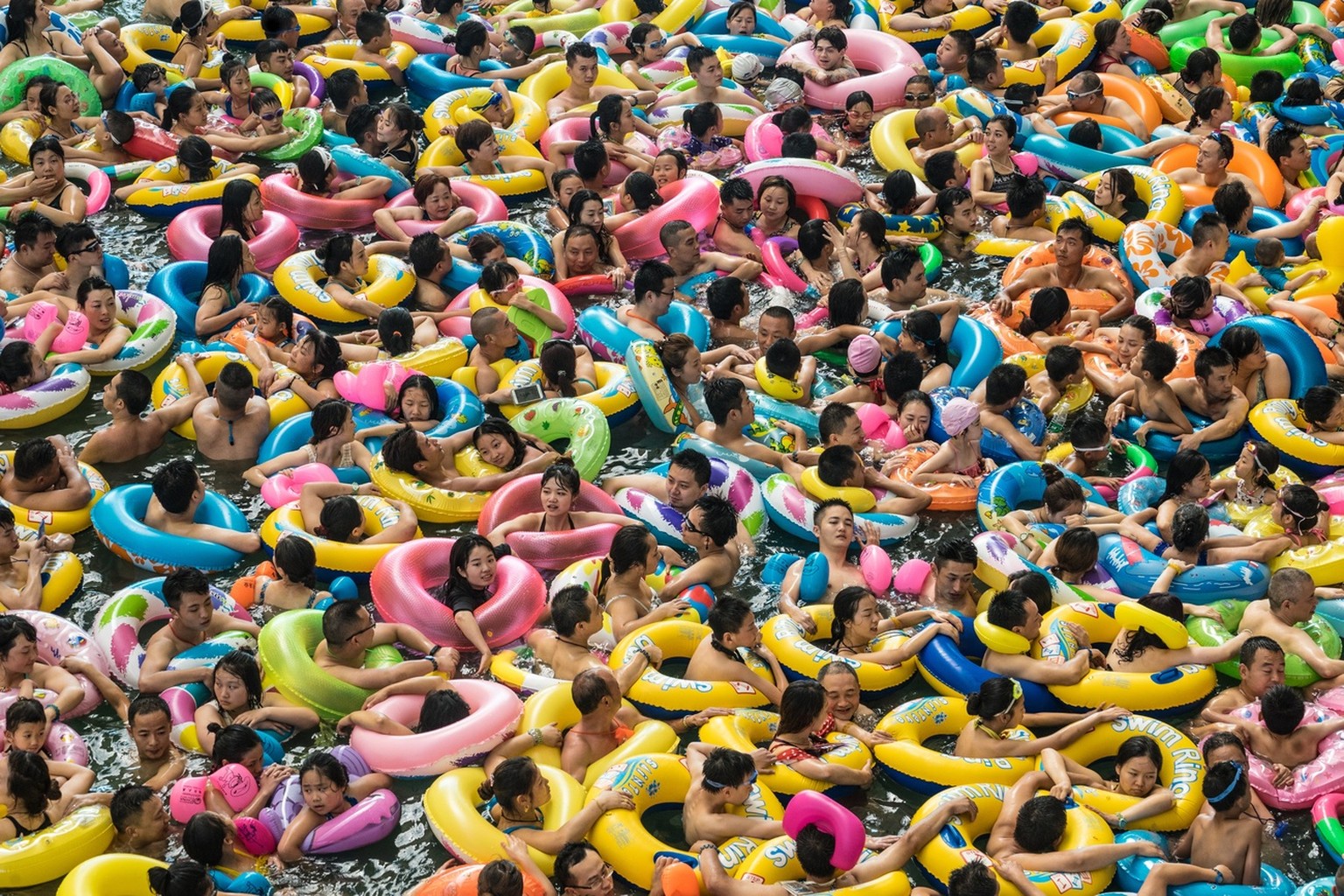 epa06260390 YEARENDER 2017 JULY..Chinese tourists with swim rings enjoy swimming in the lake called &#039;Dead sea of China&#039; in a resort of Suining city, southwestern China&#039;s Sichuan provinc ...