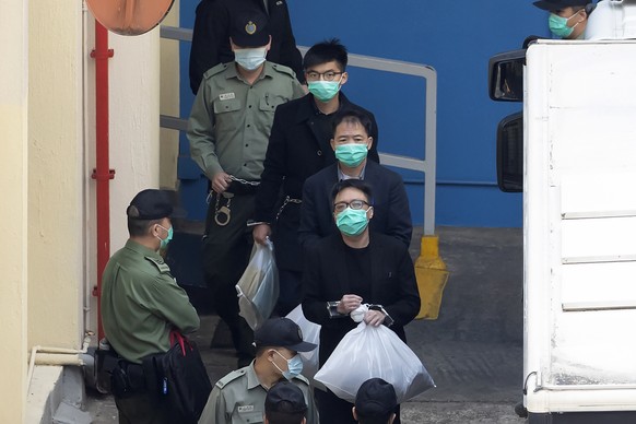From top, Joshua Wong, Wu Chi-wai and Tam Tak-chi, some of the 47 pro-democracy Hong Kong activists, are escorted by Correctional Services officers in Hong Kong, Tuesday, March 2, 2021. A court hearin ...