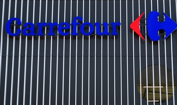 epa08937251 A Carrefour logo is seen at the entrance of the Carrefour Supermarket in Nice, France, 14 January 2020. Canadian group Couche-Tard offers to buy Carrefour for 16 billion euros. EPA/SEBASTI ...