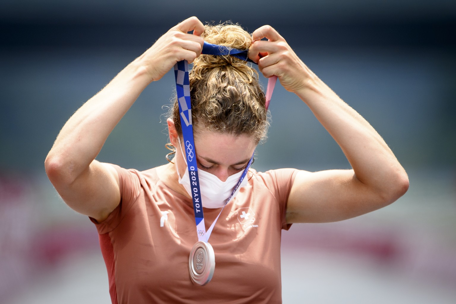 Silver medal winner Marlen Reusser of Switzerland puts her medal on during the victory ceremony after the women&#039;s cycling individual time trial at the 2020 Tokyo Summer Olympics at the Fuji Inter ...