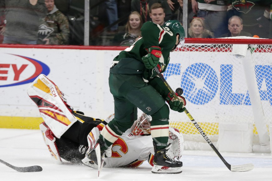 Calgary Flames goalie David Rittich (33) makes a stop on Minnesota Wild left wing Kevin Fiala in the third period during an NHL hockey game Sunday, Jan. 5, 2020, in St. Paul, Minn. The Flames defeated ...
