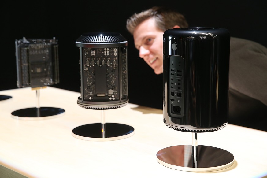 SAN FRANCISCO, CA - OCTOBER 22: An attendee looks at the new Mac Pro during an Apple announcement at the Yerba Buena Center for the Arts on October 22, 2013 in San Francisco, California. The tech gian ...
