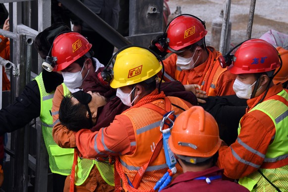 epaselect epa08961562 A picture released by Xinhua News Agency shows a trapped miner being lifted from a gold mine in Qixia City, east China&#039;s Shandong Province, 24 January 2021. The miner, who h ...
