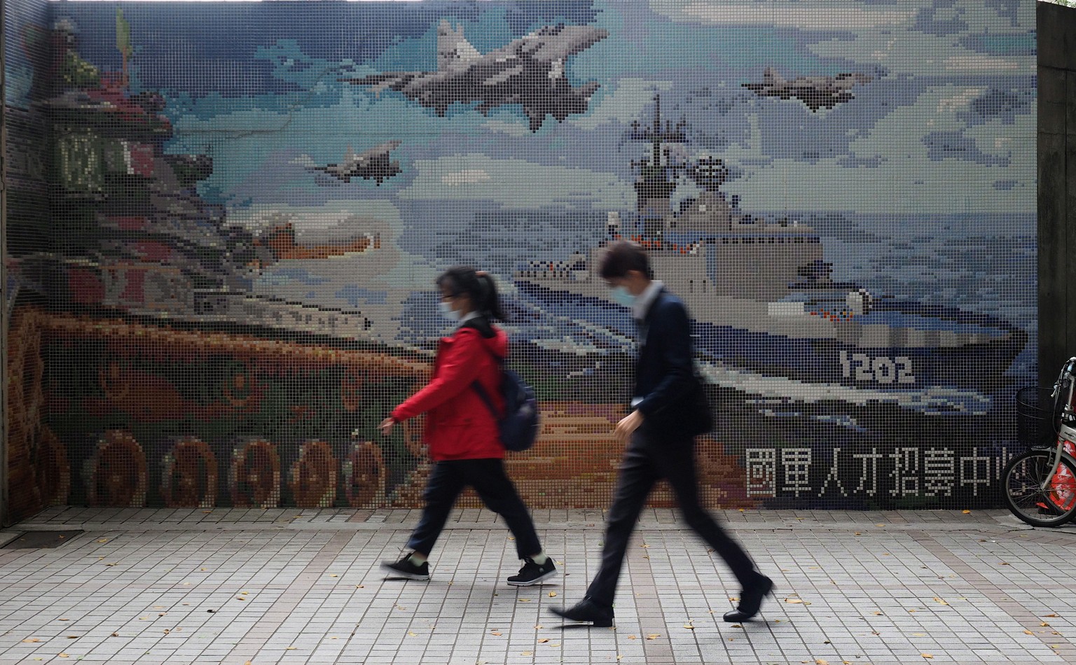 epa08726693 People walk past a wall mural showing Taiwan&#039;s military pieces in Taipei, Taiwan, 07 October 2020. According to media reports, Taiwan&#039;s Defence Minister Yen Teh-fa on 07 October  ...