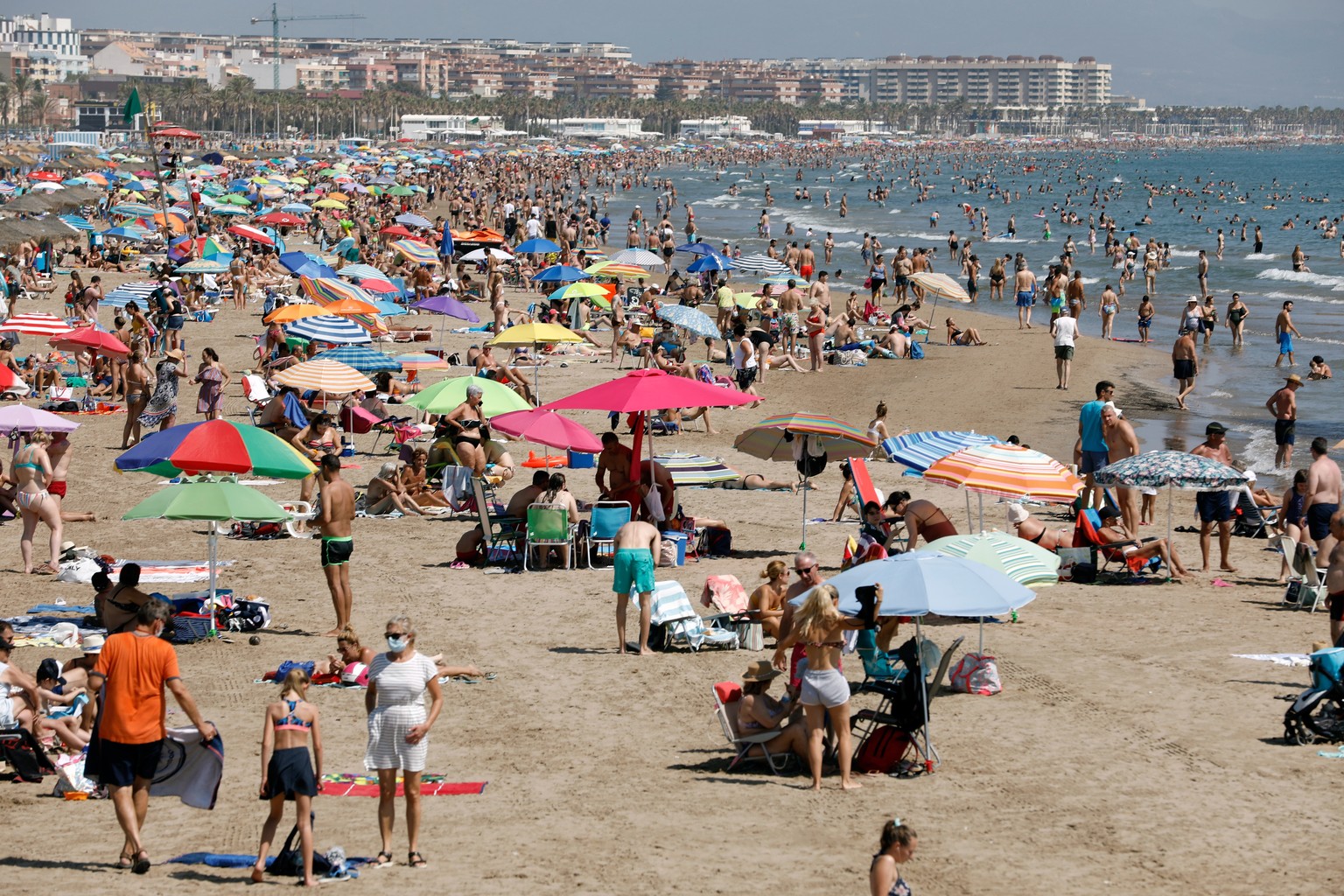 epa08554545 People sit on Malvarrosa beach in Barcelona, Spain, 19 July 2020. New restrictions have been imposed in Barcelona? and surrounding towns after a spike in COVID-19 infection was reported. E ...