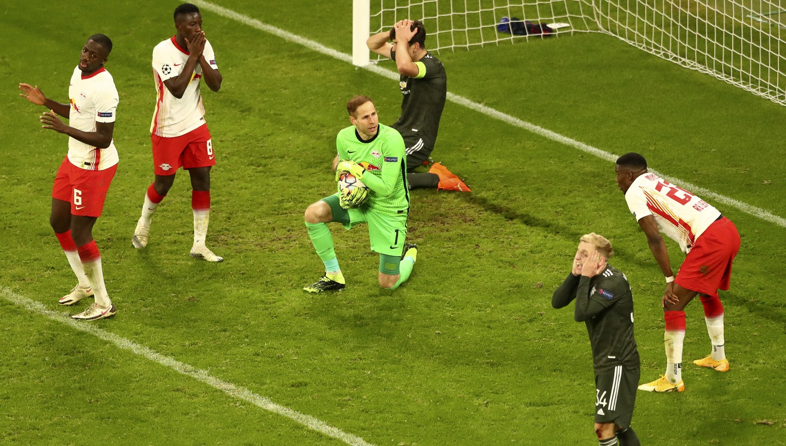 Manchester United&#039;s Donny van der Beek, foreground right, and team mate Harry Maguire, background top, react as Leipzig&#039;s goalkeeper Peter Gulacsi saves the ball during the Champions League  ...