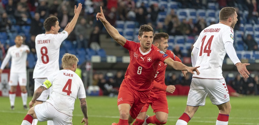 Switzerland&#039;s Remo Freuler, center, cheeers after scoring during the UEFA Euro 2020 qualifying Group D soccer match between Switzerland and Denmark at the St. Jakob-Park stadium in Basel, Switzer ...