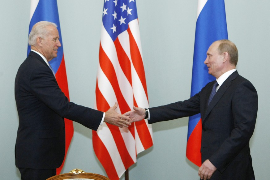 FILE - In this March 10, 2011, file photo, then Vice President Joe Biden, left, shakes hands with Russian Prime Minister Vladimir Putin in Moscow, Russia. The White House and the Kremlin are working t ...