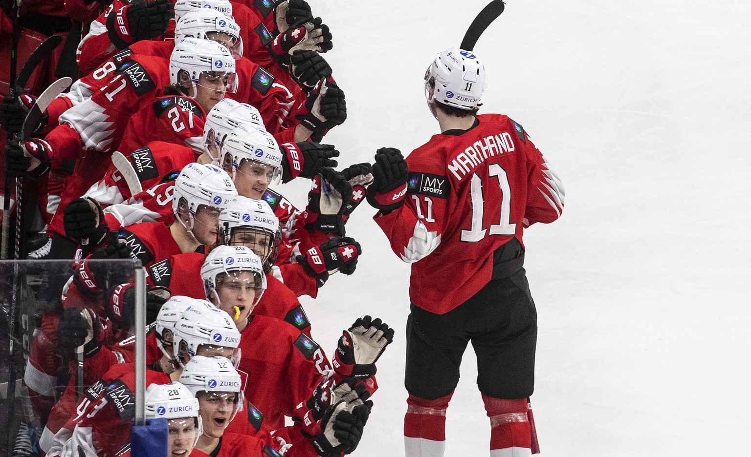 Switzerland&#039;s Lionel Marchand (11) celebrates his goal against Austria with teammates during the third period of a game in preparation for the IIHF World Junior Hockey Championships, in Edmonton, ...