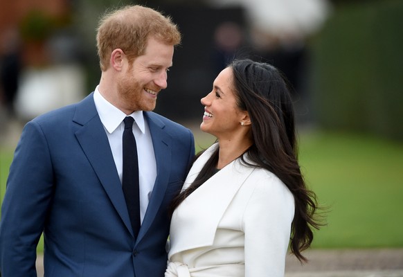 epa09004768 (FILE) - Britain&#039;s Prince Harry pose with Meghan Markle during a photocall after announcing their engagement in the Sunken Garden in Kensington Palace in London, Britain, 27 November  ...