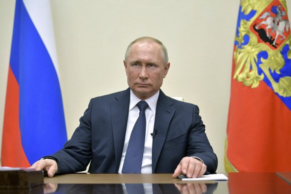 Russian President Vladimir Putin addresses Russian citizens on the State Television channels at the Novo-Ogaryovo residence outside Moscow, Russia, Wednesday, March 25, 2020. Putin has ordered most Ru ...