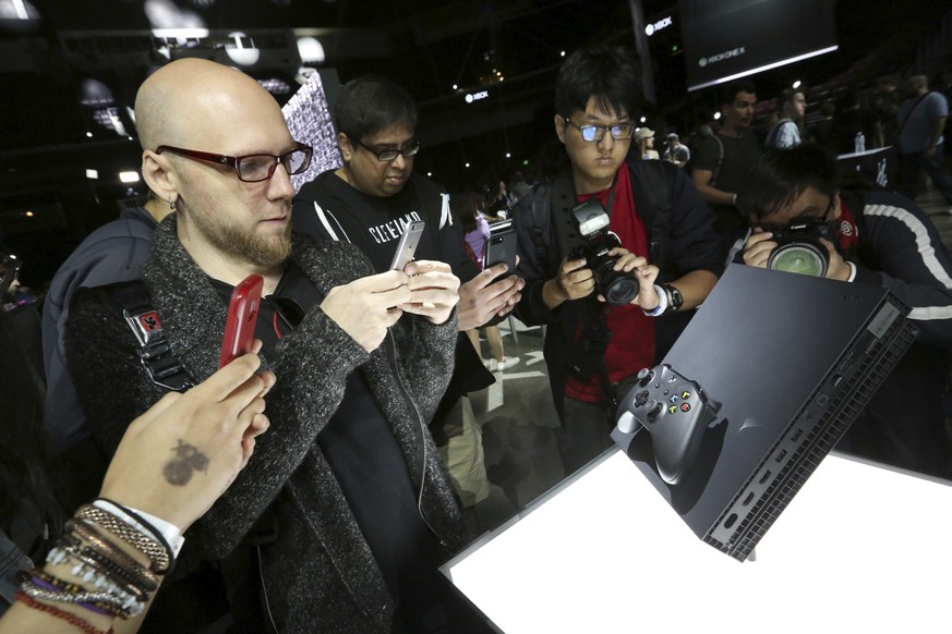 IMAGE DISTRIBUTED FOR MICROSOFT - Fans interact with the Xbox One X at the Xbox Media Showcase at E3 2017 in Los Angeles on Monday, June 12, 2017. (Photo by Casey Rodgers/Invision for Microsoft/AP Ima ...