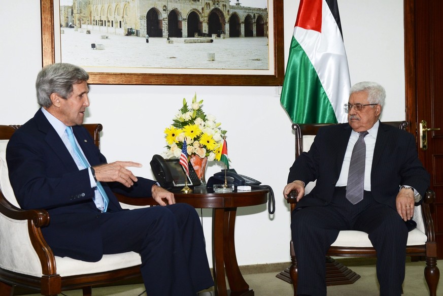 epa03767436 A handout photograph provided by the Palestinian Authority shows US Secretary of State John Kerry (L )meets the Palestinian President Mahmoud Abbas (R) on his arrival in the &#039;Muqata&# ...