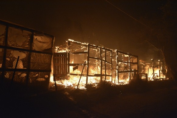 Fire burns makeshift tents at the Moria refugee camp on the northeastern Aegean island of Lesbos, Greece, on Wednesday, Sept. 9, 2020. Fire Service officials say a large refugee camp on the Greek isla ...