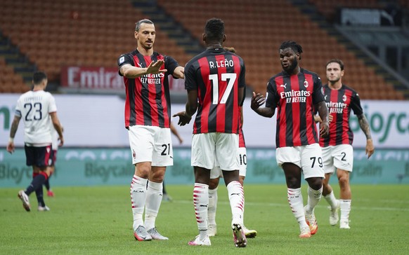 Milan&#039;s team players Zlatan Ibrahimovic, left, Rafael Leao, and Franck Kessie celebrates after scoring the first goal during a Serie A soccer match between Milan and Cagliari, at the San Siro sta ...