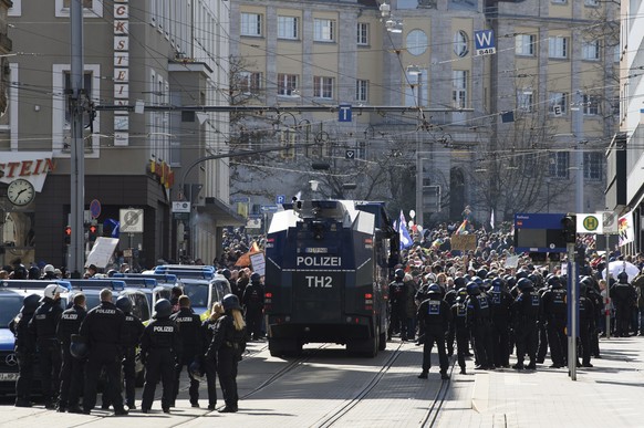 Police forces stand next to a water canon during a rally under the motto &quot;Free citizens Kassel - basic rights and democracy&quot; i Kassel, Germany, Saturday, March 20, 2021. According to police, ...