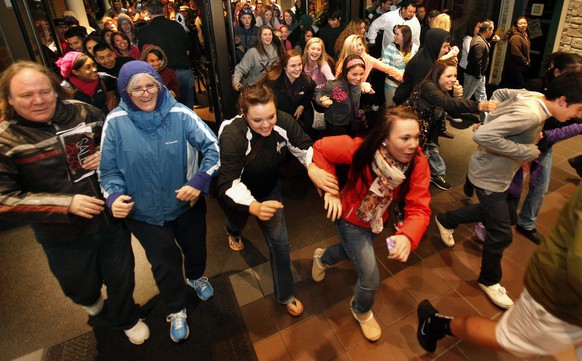 Black Friday shoppers pour into the Valley River Center mall for the Midnight Madness sale Friday, Nov. 23, 2012 in Eugene, Ore. For decades, stores have opened their doors in wee hours of the morning ...