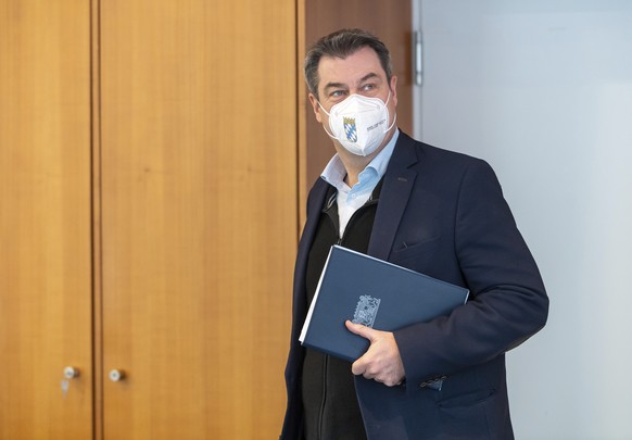 Bavarian governor Markus Soeder arrives for a meeting of the Bavarian state cabinet, which take place as a video conference in Munich, Germany, Tuesday, April 20, 2021. (Peter Kneffel/Pool via AP)