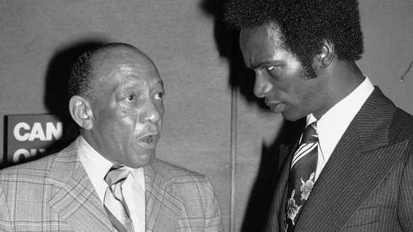 Olympic gold medallists Jesse Owens, left, and Bob Beamon exchange views as they meet at a breakfast in New York on May 25, 1976. Owens, who won his medal for the so-called &quot;Nazi Games&quot;; is  ...